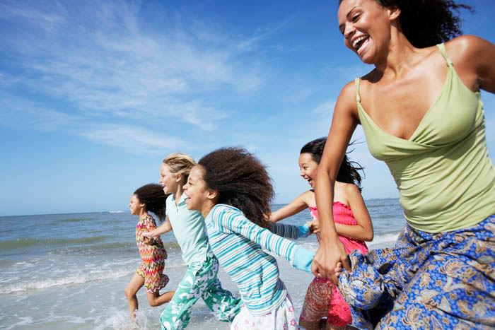 Woman and Children Running on the Beach