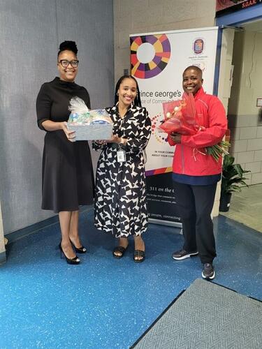 County employees presenting some gifts to school principal.