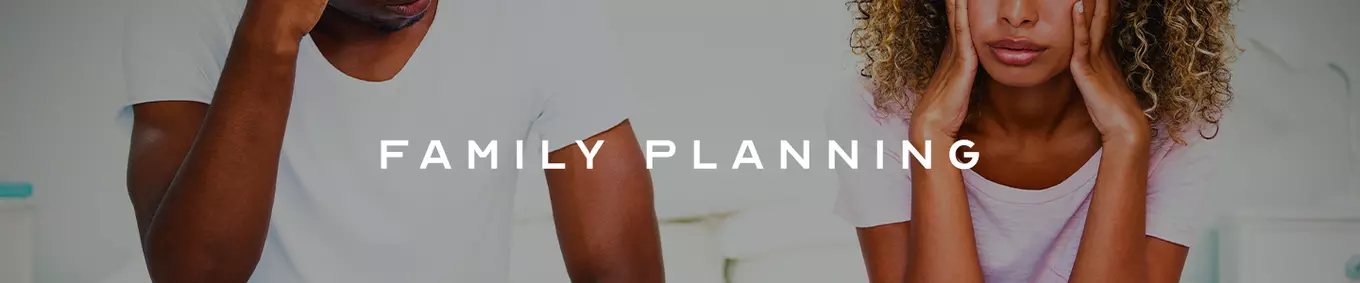 A stressed couple sitting separately from each other with the title family planning in front of them.