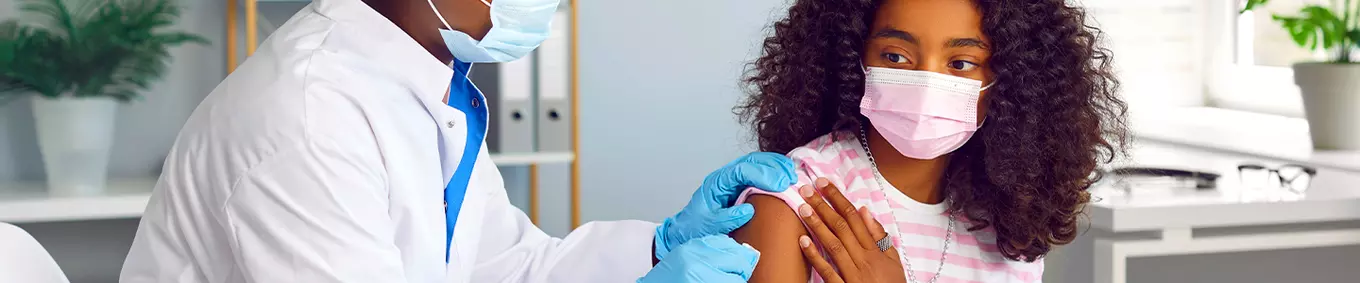 A student receiving their yearly back-to-school immunization shot. 