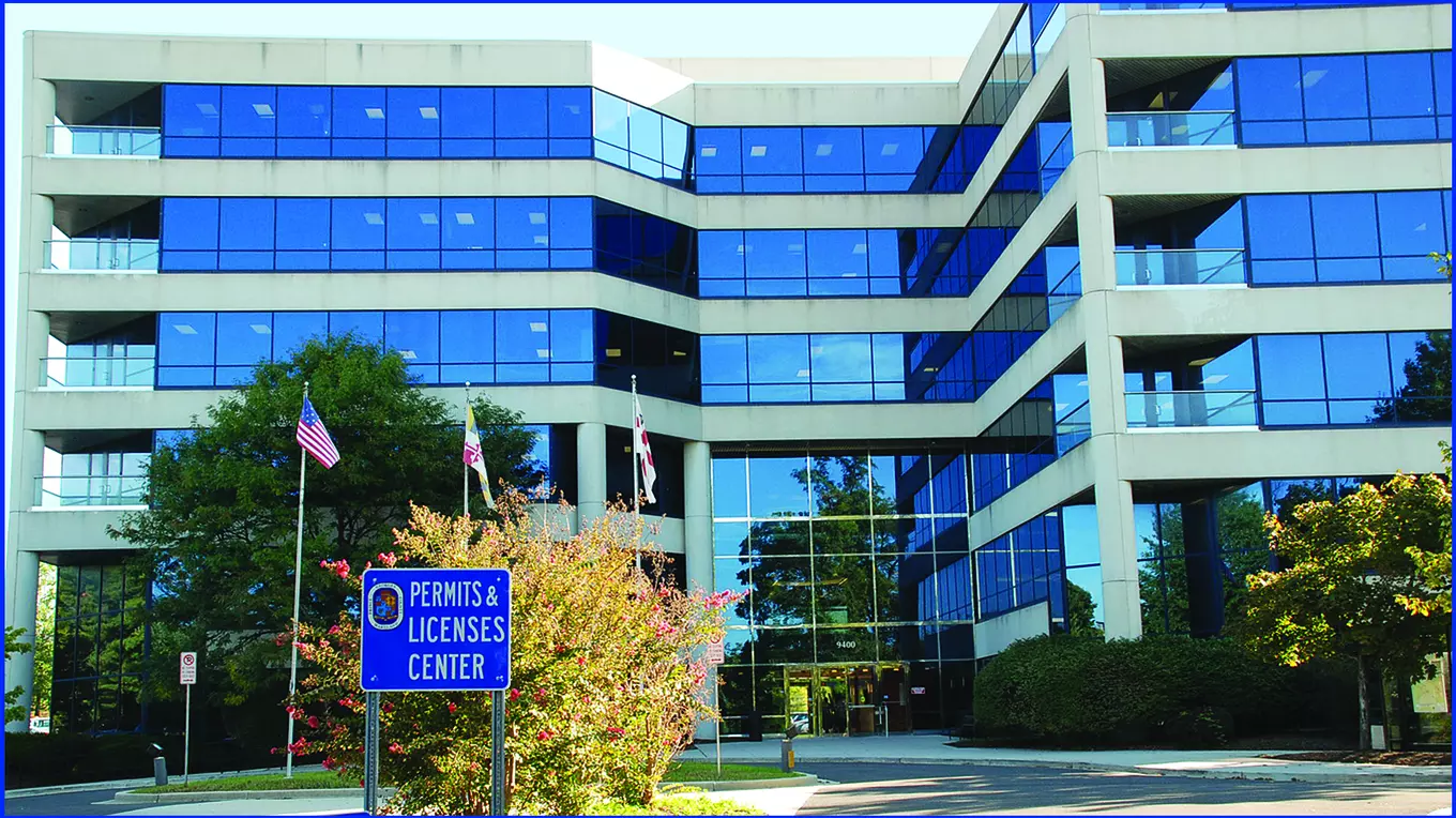 Photo of DPIE building at Peppercorn Place with Permits & Licenses sign in front