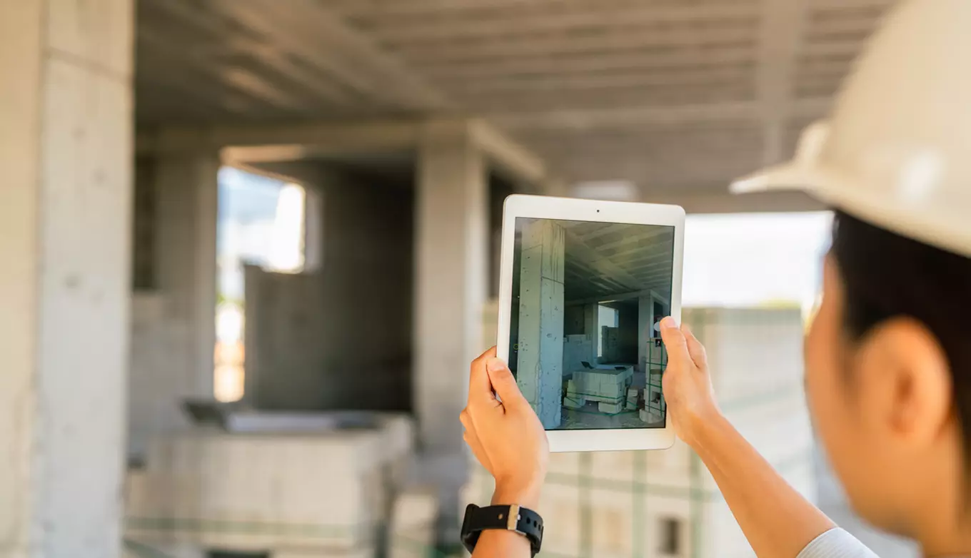 Virtual inspection with Inspector holding iPad up for recordation