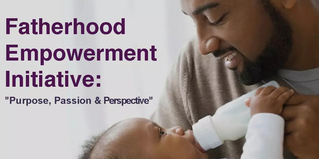 An African American dad happily bottle feeding his son. Fatherhood Empowerment Initiative: Purpose, Passion and Perspective.