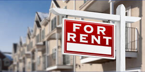 Rent Stabilization Law, row of multifamily housing with a "For Rent" sign in front of the building