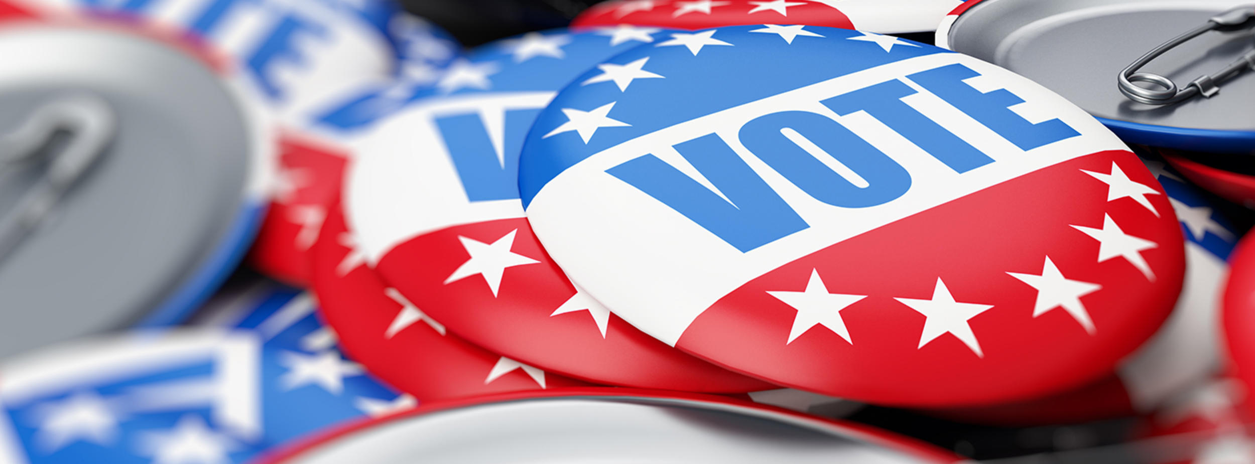 red, white, and blue buttons with the word "vote" on them